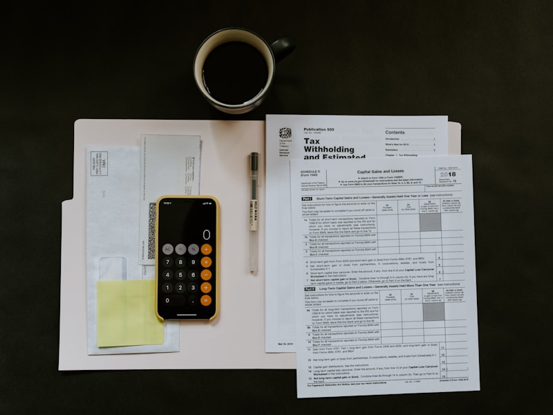 Tax compliance documents and certificate on a white surface
